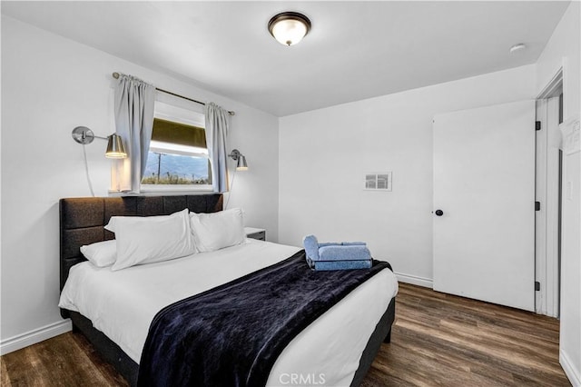 bedroom featuring dark wood-type flooring