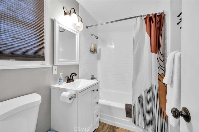 full bathroom with vanity, wood-type flooring, shower / bath combination with curtain, and toilet