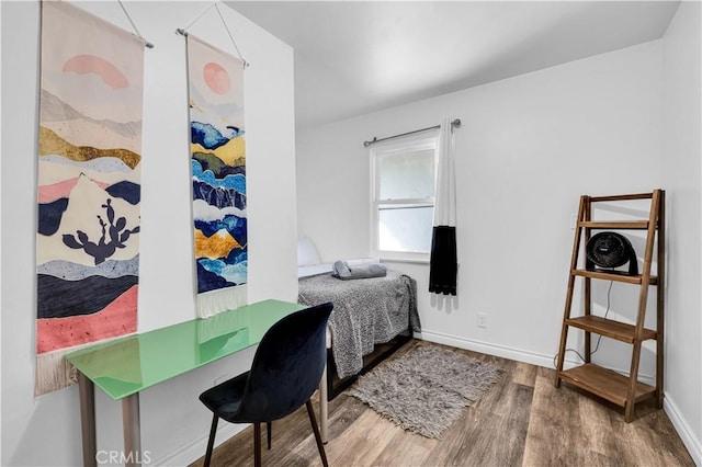 bedroom with hardwood / wood-style floors