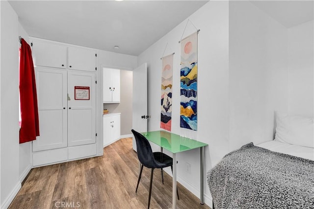 bedroom with hardwood / wood-style flooring