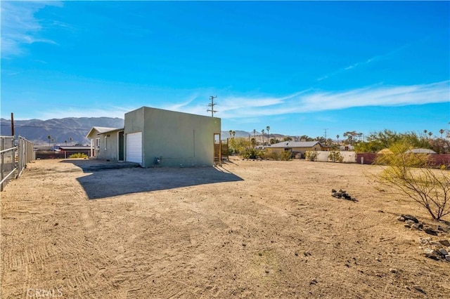 exterior space with a garage and a mountain view