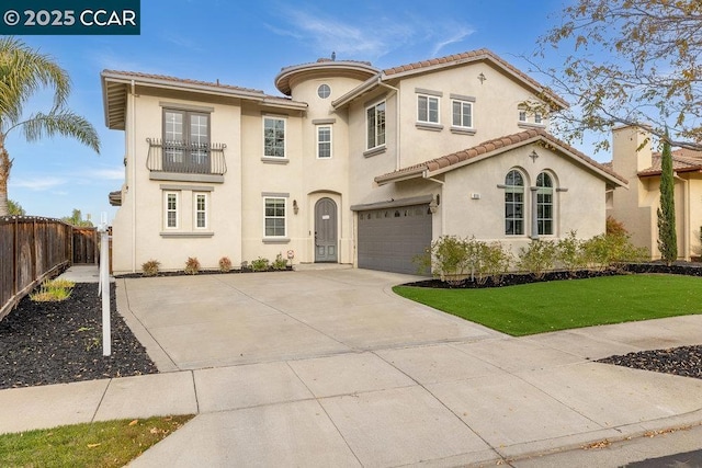 mediterranean / spanish home with a garage and a front lawn