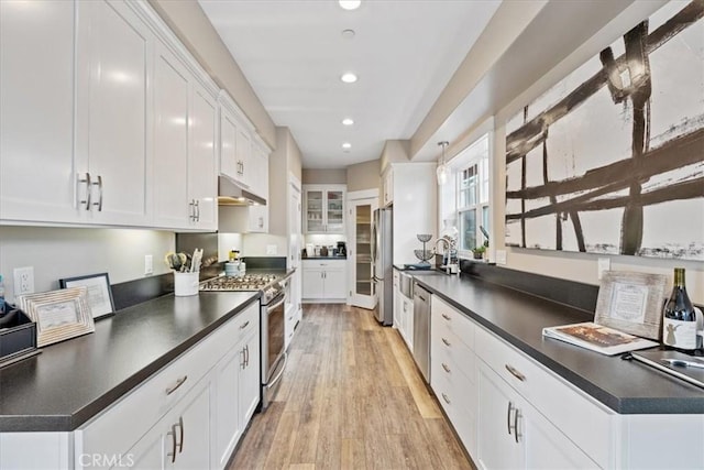 kitchen with white cabinetry, sink, light hardwood / wood-style flooring, and stainless steel appliances