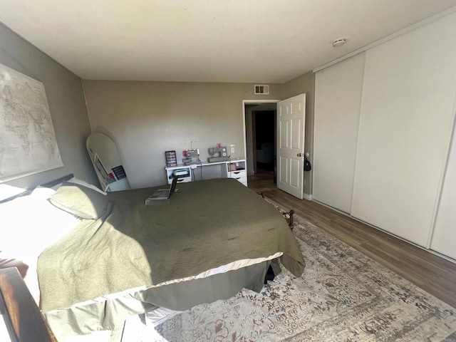 bedroom featuring hardwood / wood-style flooring and a closet