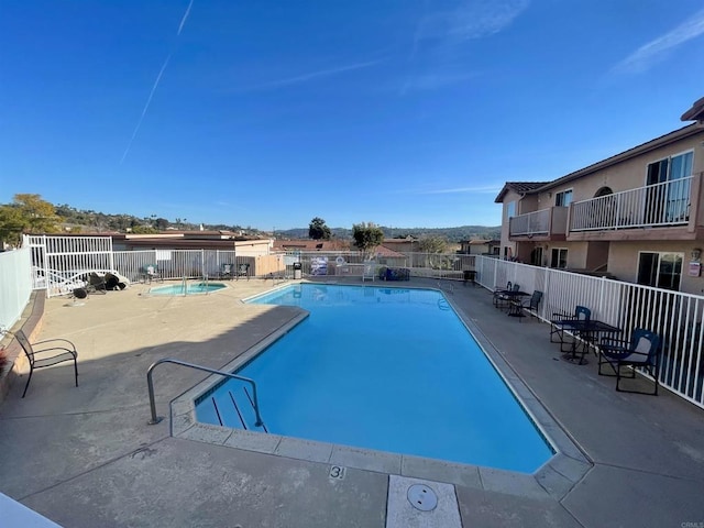 view of swimming pool featuring a patio area