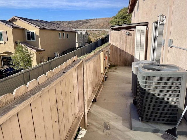 view of side of property featuring a mountain view and central air condition unit