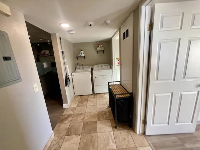 laundry room with washer and clothes dryer and electric panel