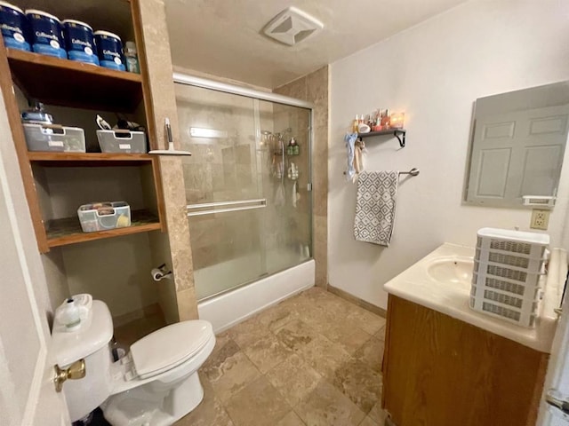 bathroom featuring vanity, toilet, and an enclosed shower