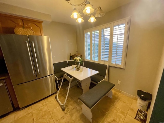 dining space featuring an inviting chandelier and light tile patterned floors