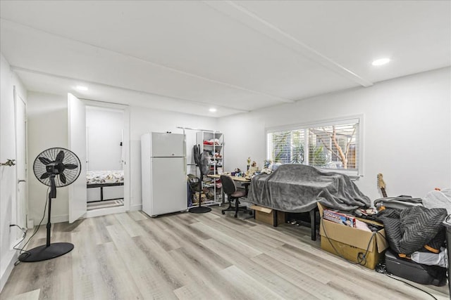 bedroom featuring white fridge and light hardwood / wood-style flooring