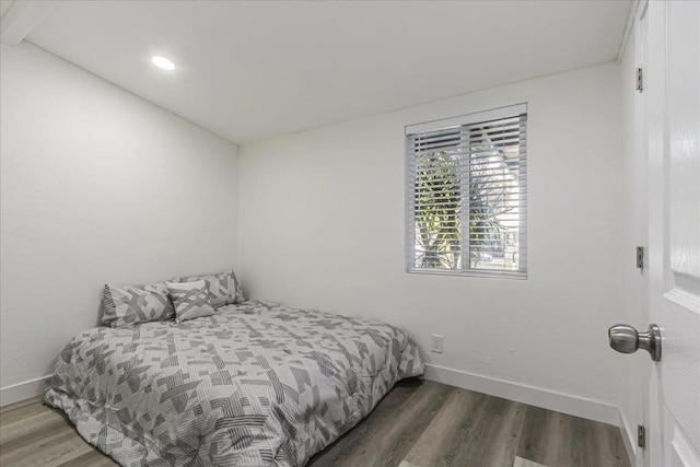 bedroom with dark hardwood / wood-style floors