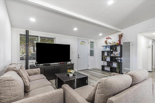 living room with lofted ceiling with beams and light wood-type flooring