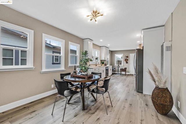 dining area featuring sink and light wood-type flooring