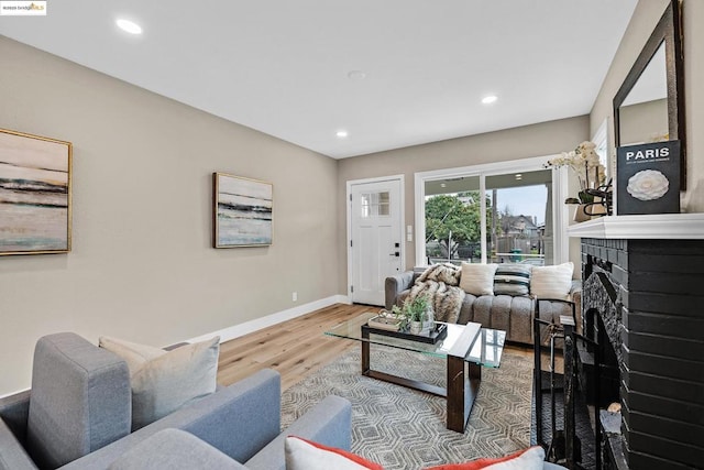 living room with hardwood / wood-style floors and a fireplace