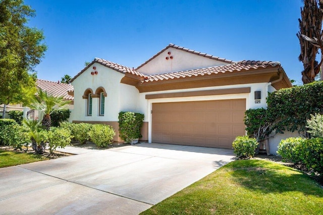 mediterranean / spanish-style house with a garage