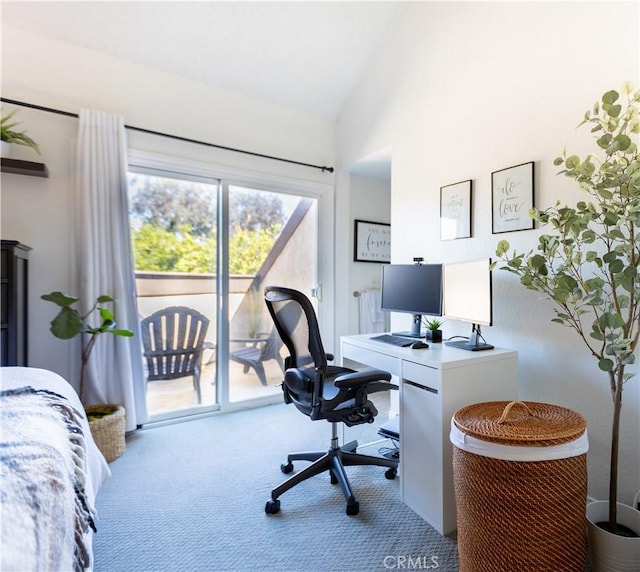 carpeted office space featuring vaulted ceiling