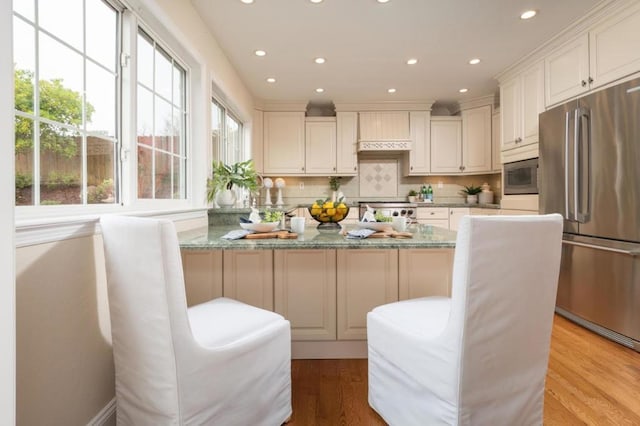 kitchen with light stone countertops, white cabinets, and appliances with stainless steel finishes