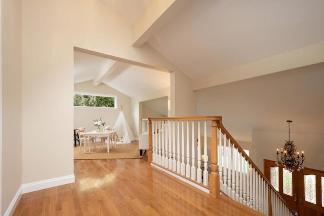 bonus room featuring lofted ceiling with beams, a chandelier, and light wood-type flooring