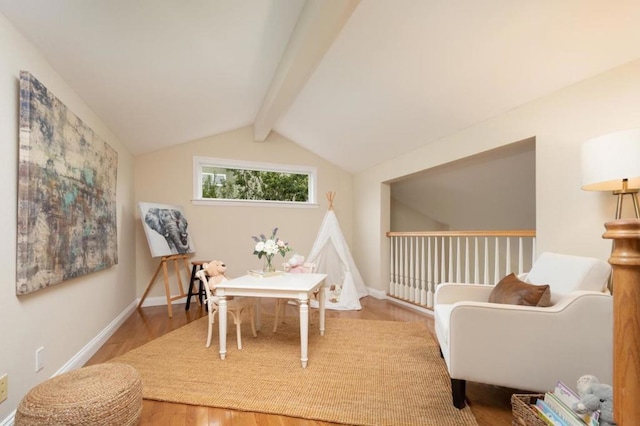 living area featuring lofted ceiling with beams and hardwood / wood-style floors