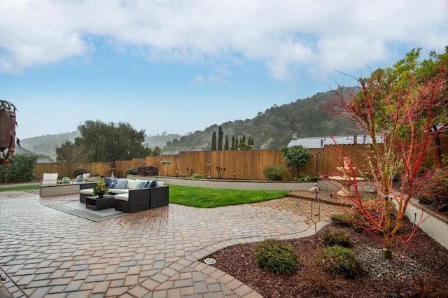 view of patio / terrace featuring an outdoor living space and a mountain view