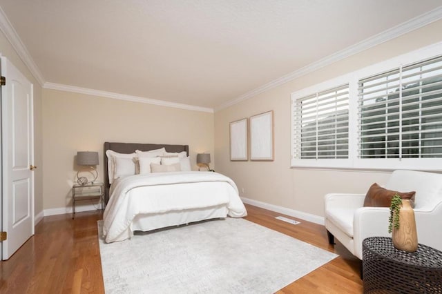 bedroom featuring ornamental molding and wood-type flooring