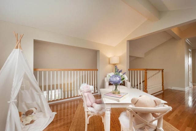 interior space with hardwood / wood-style floors and vaulted ceiling with beams