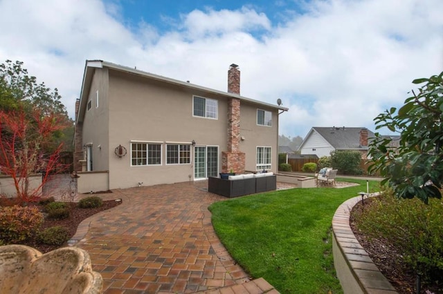 rear view of house with an outdoor living space, a patio, and a yard