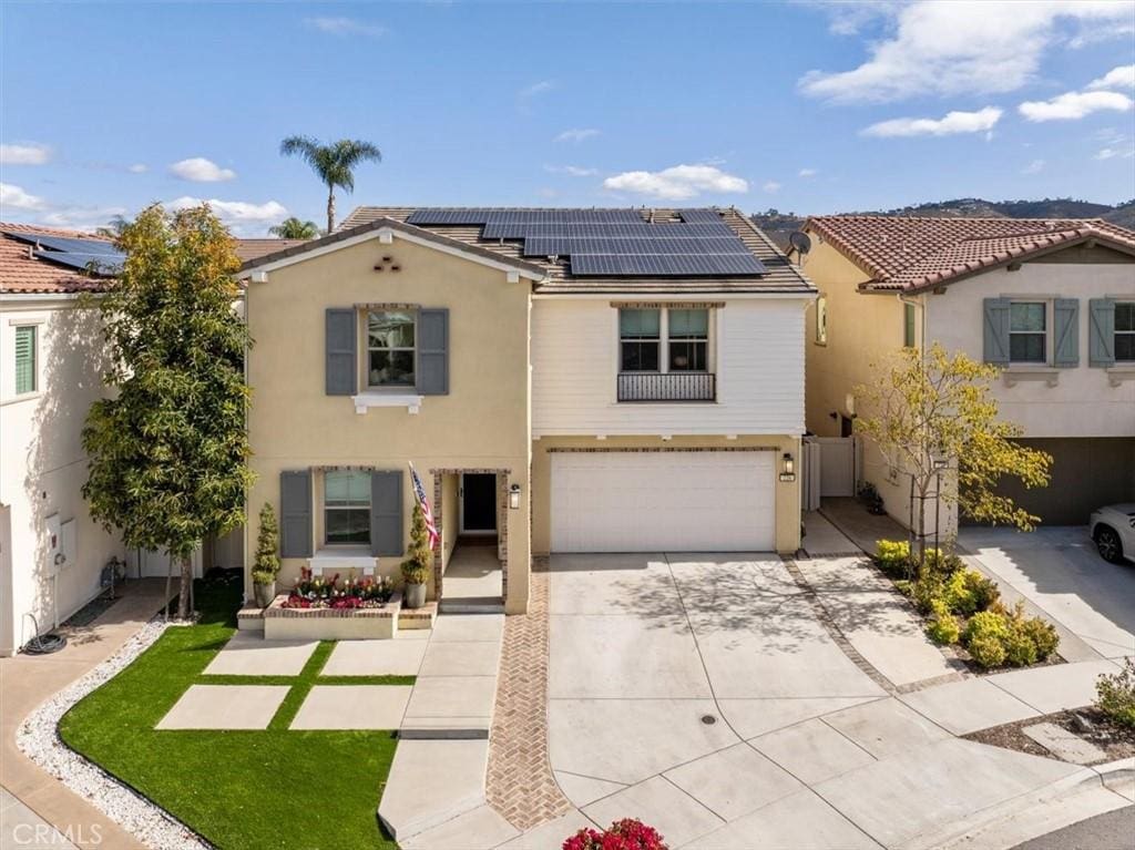 view of front of home featuring a garage and solar panels