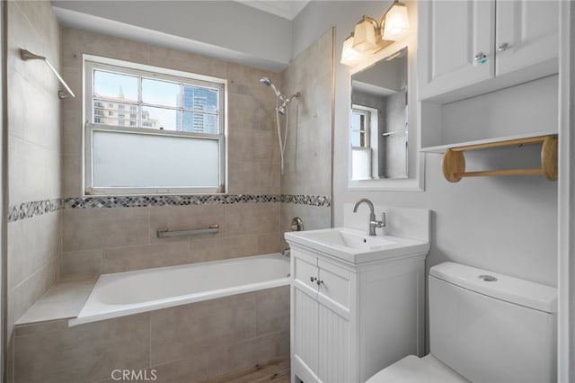 full bathroom with vanity, toilet, and tiled shower / bath combo