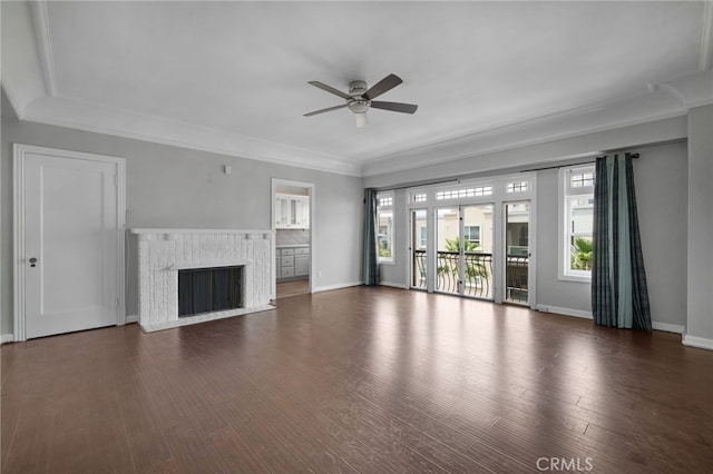 unfurnished living room featuring ceiling fan, a high end fireplace, dark hardwood / wood-style flooring, and ornamental molding