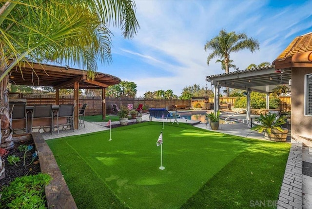 view of yard featuring a fenced in pool, a pergola, an outdoor bar, and a patio