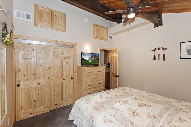 carpeted bedroom featuring vaulted ceiling with beams