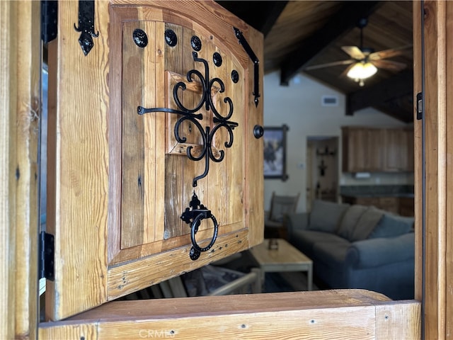 interior details featuring beamed ceiling and ceiling fan