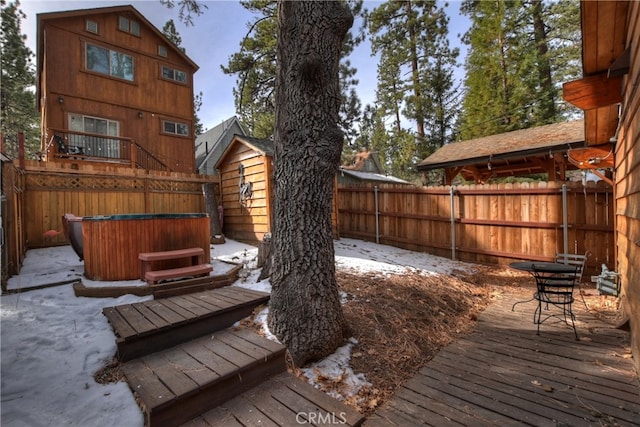 wooden terrace with a hot tub