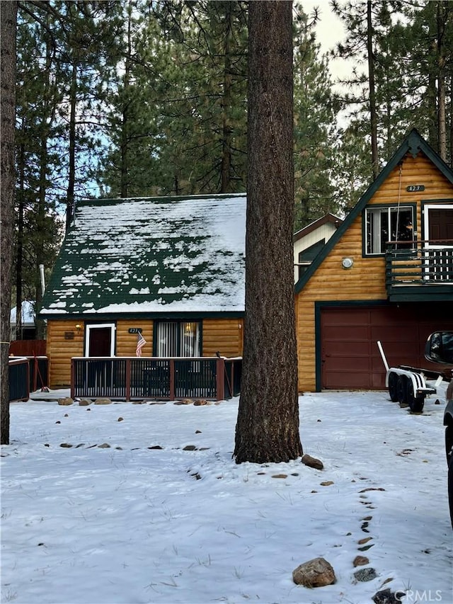 log-style house featuring a garage