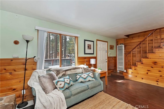 living room featuring hardwood / wood-style floors and wooden walls