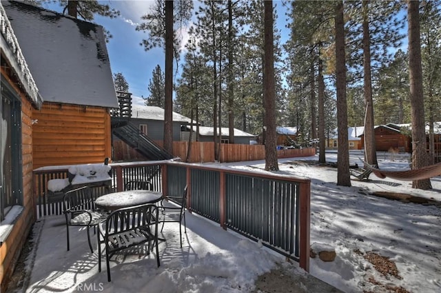 view of snow covered back of property