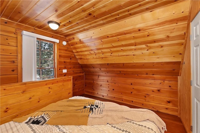 bedroom featuring wood ceiling, wooden walls, wood-type flooring, and vaulted ceiling