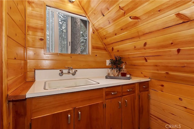 bathroom with vanity, vaulted ceiling, wood ceiling, and wooden walls