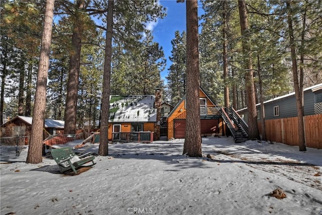 log-style house featuring a playground