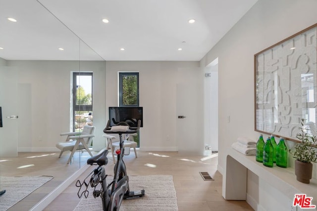 exercise area with light hardwood / wood-style floors