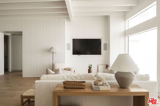 living room with wood-type flooring and beam ceiling