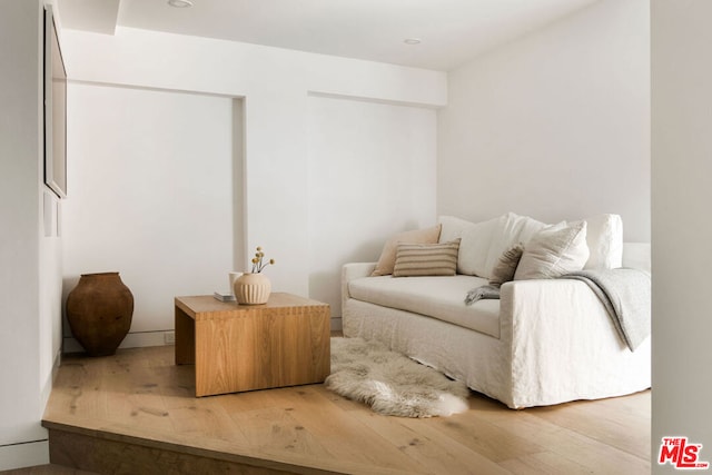 sitting room with hardwood / wood-style flooring