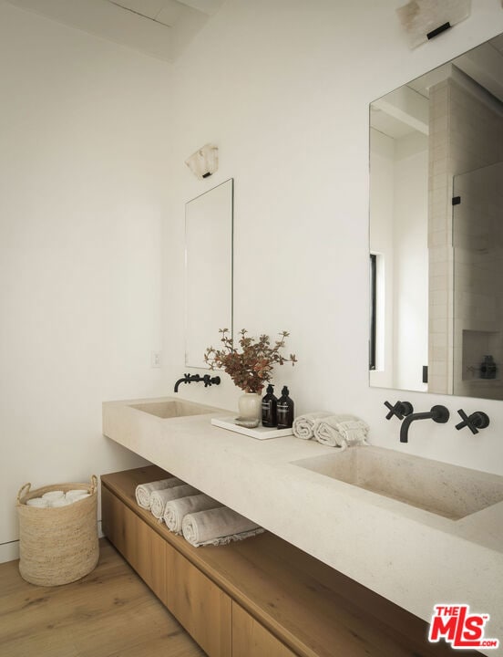 bathroom featuring hardwood / wood-style flooring and vanity