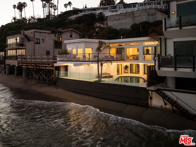 rear view of property with a water view