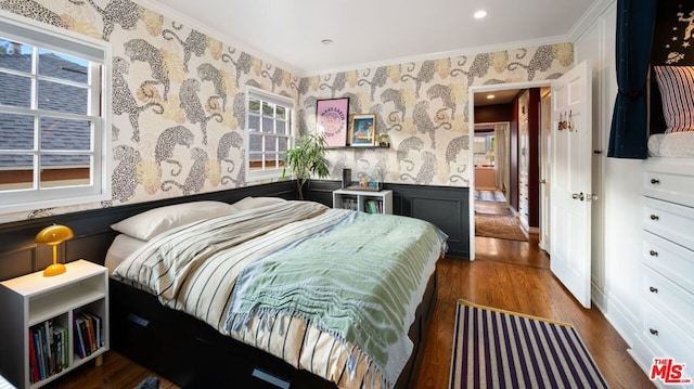 bedroom with crown molding and dark wood-type flooring