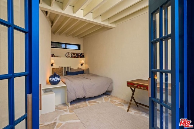 bedroom featuring beam ceiling