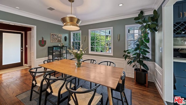 dining area with dark hardwood / wood-style flooring and ornamental molding