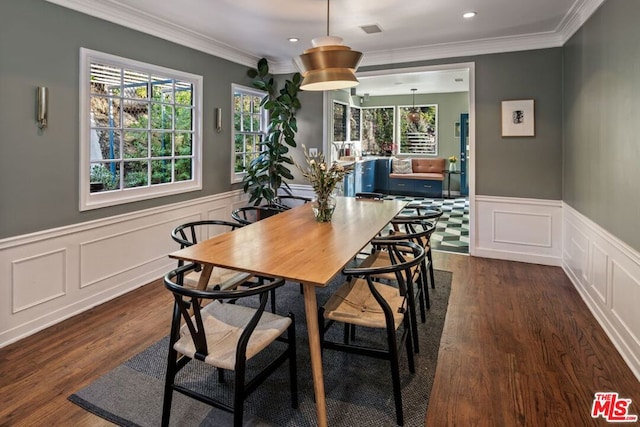 dining room with ornamental molding and dark hardwood / wood-style floors