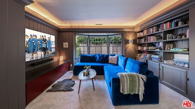 home theater room with light colored carpet and wood walls